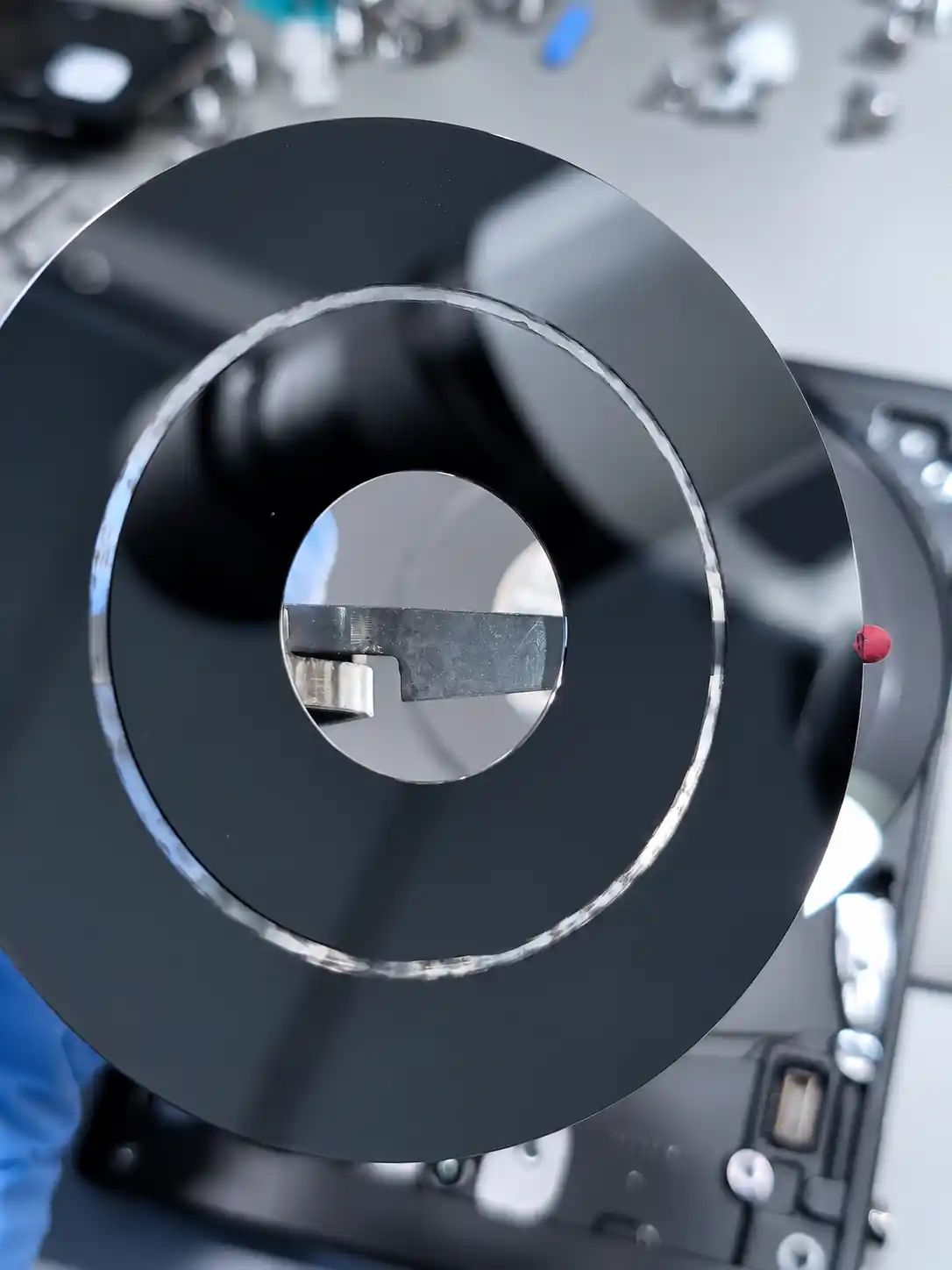Hard drive platter being evaluated for media damage