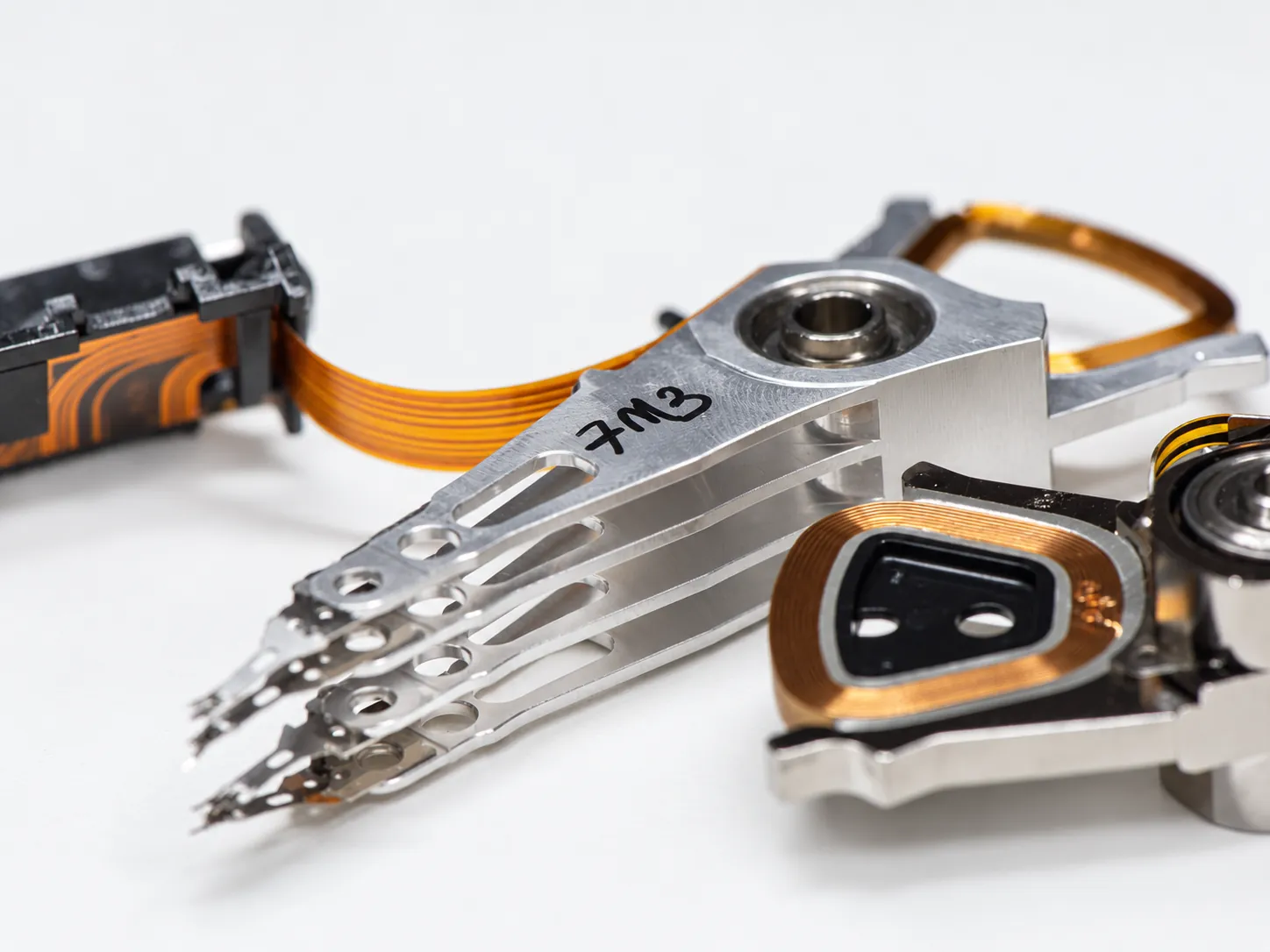 Previously attempted hard drive recovery case showing altered parts and prior recovery work