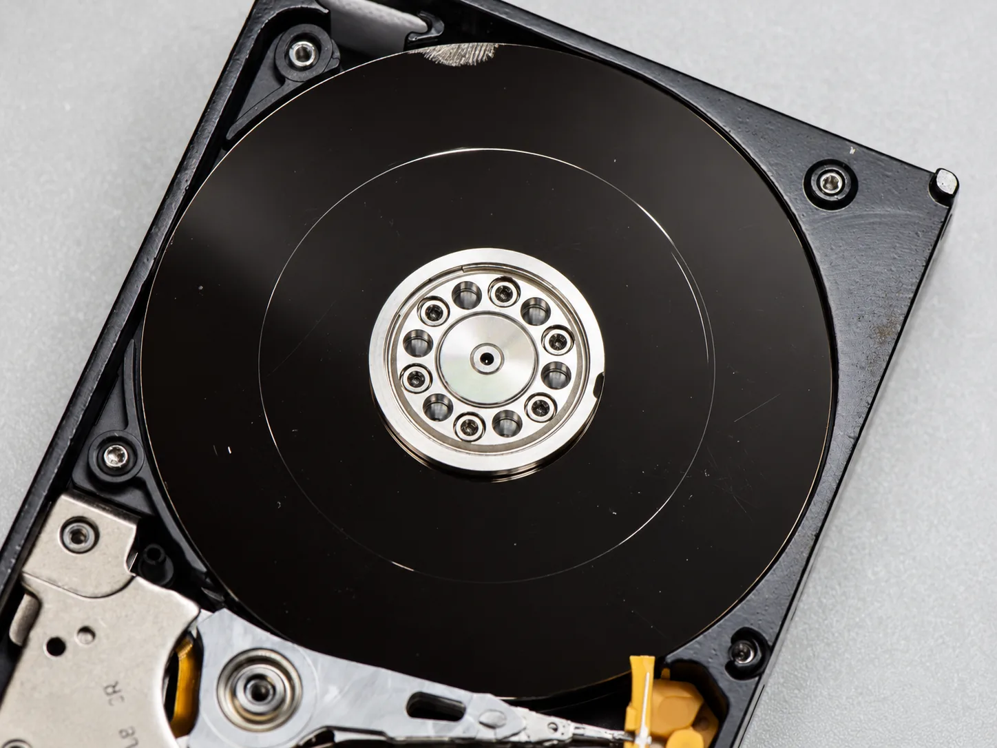 Severely scratched hard drive platter from a previously attempted recovery case