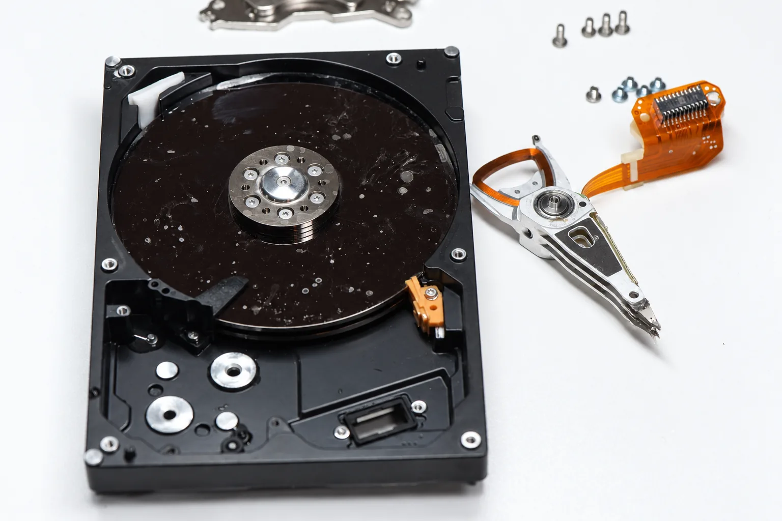 Water-damaged hard drive opened for inspection with the head stack removed