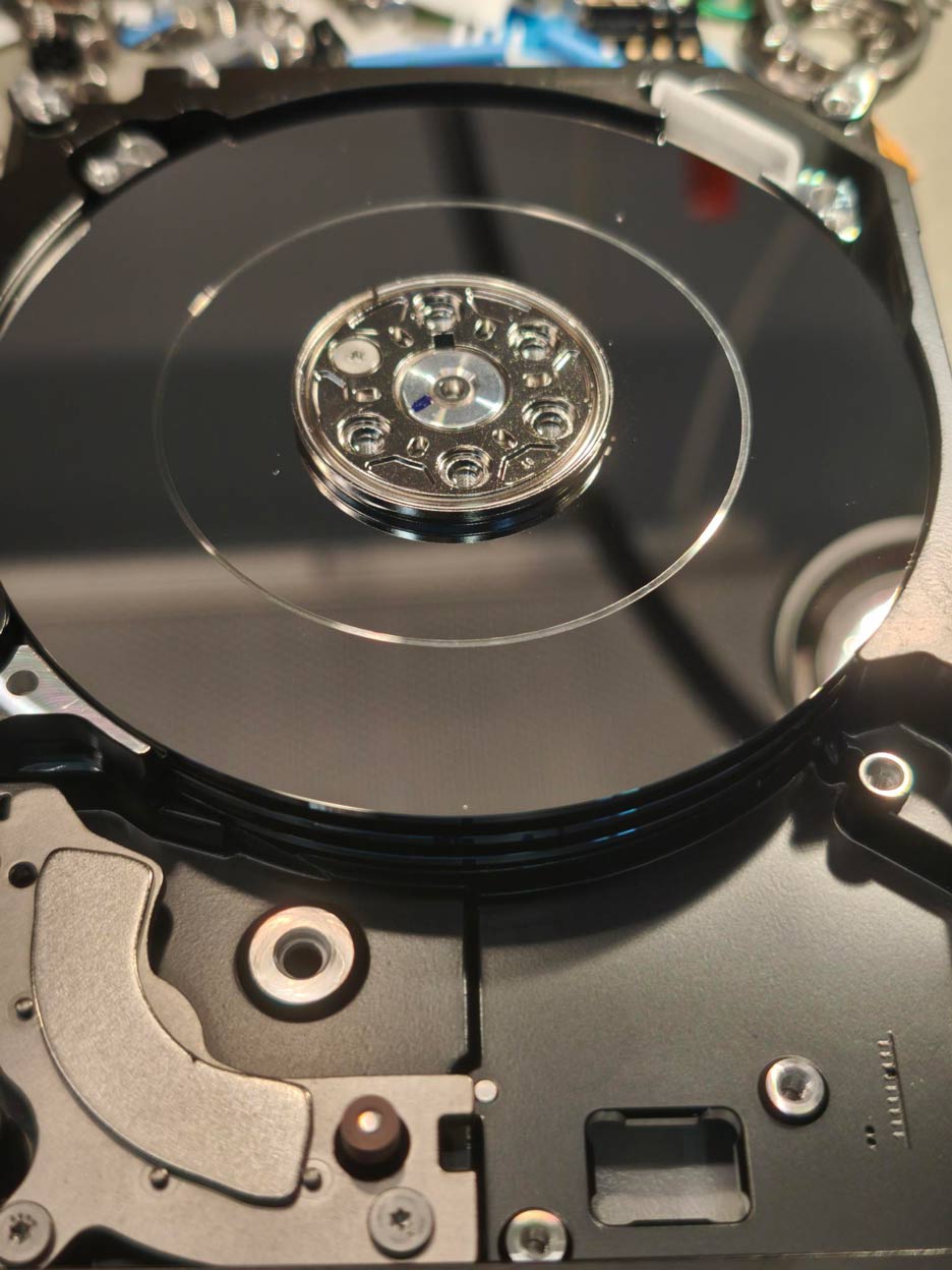Hard drive platter showing physical scoring caused by head to media contact