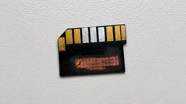 Exposed internal circuitry of a monolithic SD card during data recovery preparation